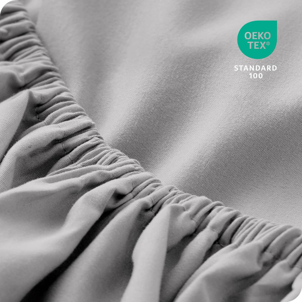Light grey fitted sheet corner with elastic gathered ruffle detail