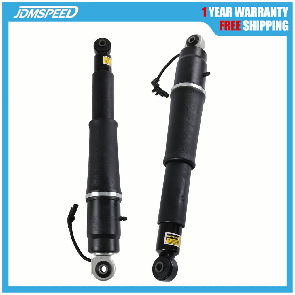 Pair of black rear air shock absorbers with metal lower mounts and wiring harness