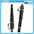 Pair of black rear air shock absorbers with metal lower mounts and wiring harness