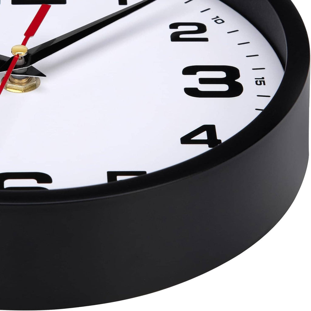 Close-up of black rim and white clock face with large numerals and red hand