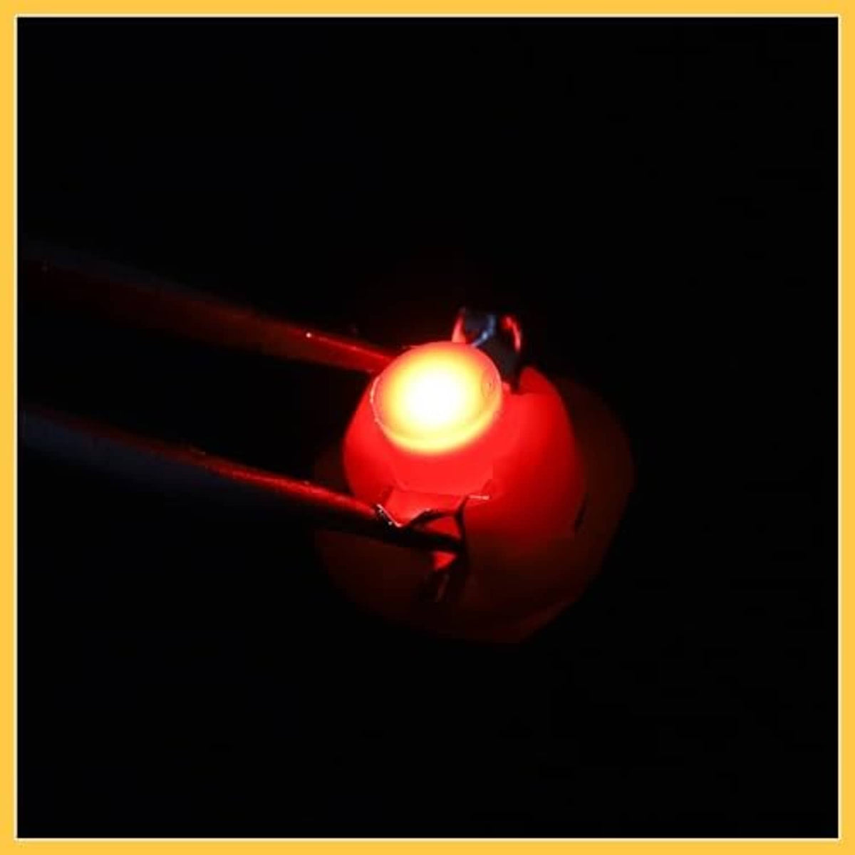 Red B8.4D LED bulb lit, showing bright warm red glow near the pin ends