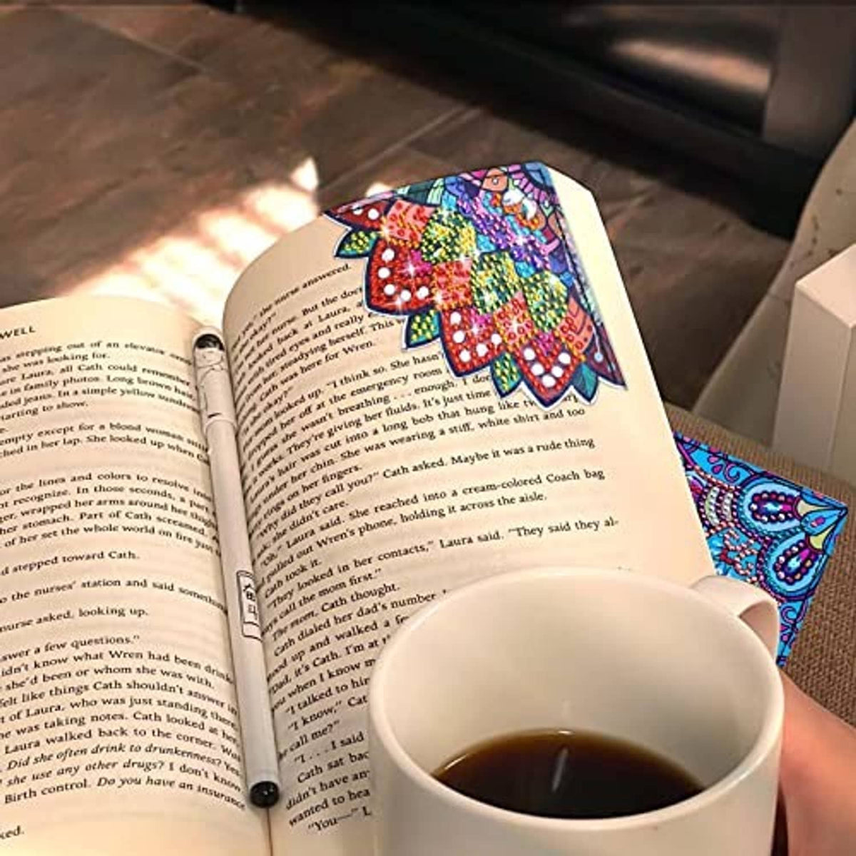 Diamond art bookmark with colorful mandala design tucked into an open book page