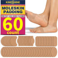 Beige moleskin adhesive blister-prevention strips on feet with layered strip set