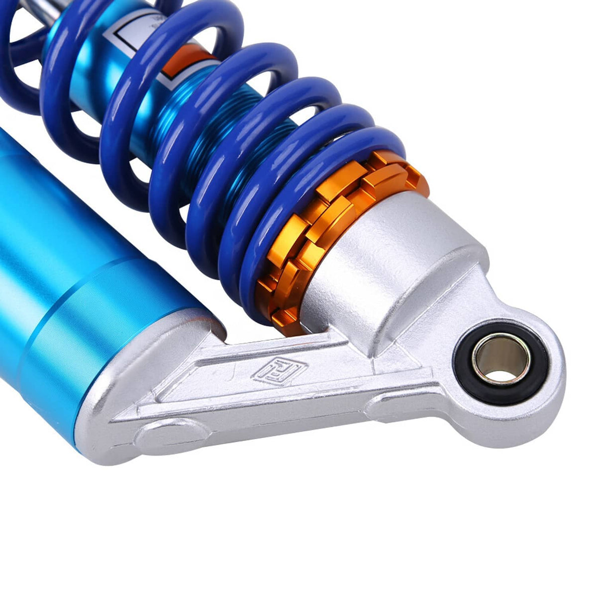 ATV rear shock mounting arm close-up with blue coil spring and blue reservoir