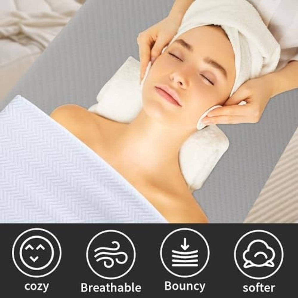 Grey massage table topper cushion on a treatment table with a soft padded surface