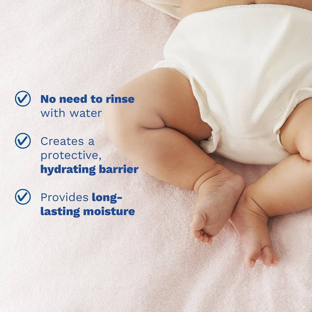 Baby in diaper on towel with no-rinse protective barrier cleanser callouts