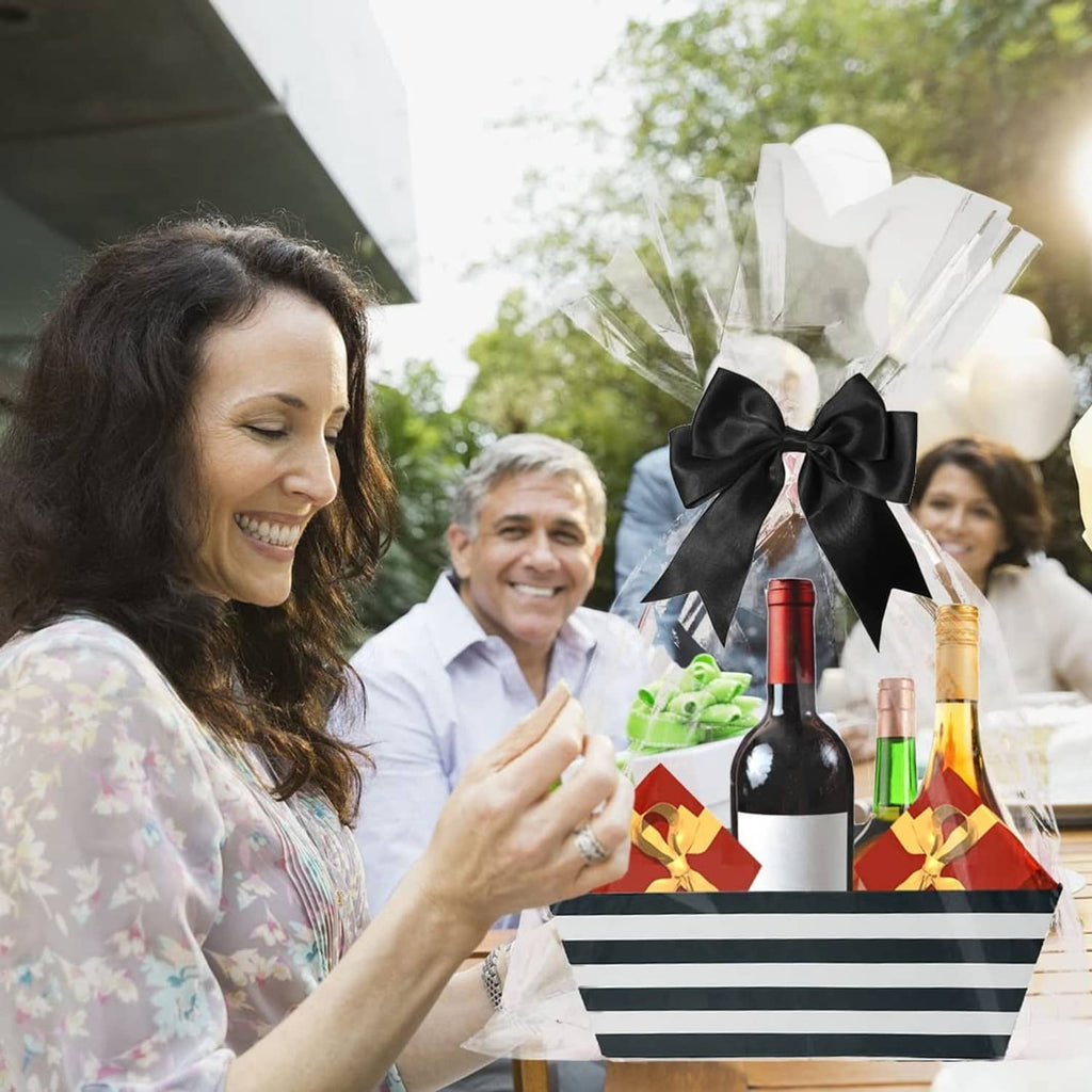 Black and white striped gift basket with black bow held at an outdoor gathering