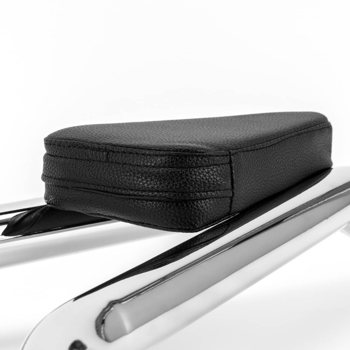 Black backrest cushion with textured surface and stitched edges on chrome bar.