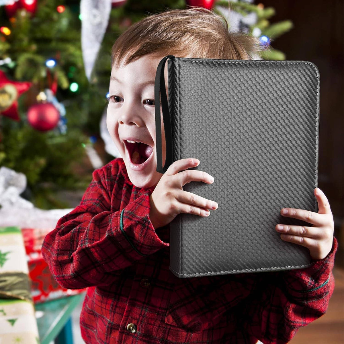 Black zip card binder with carbon-fiber texture, held up by a child