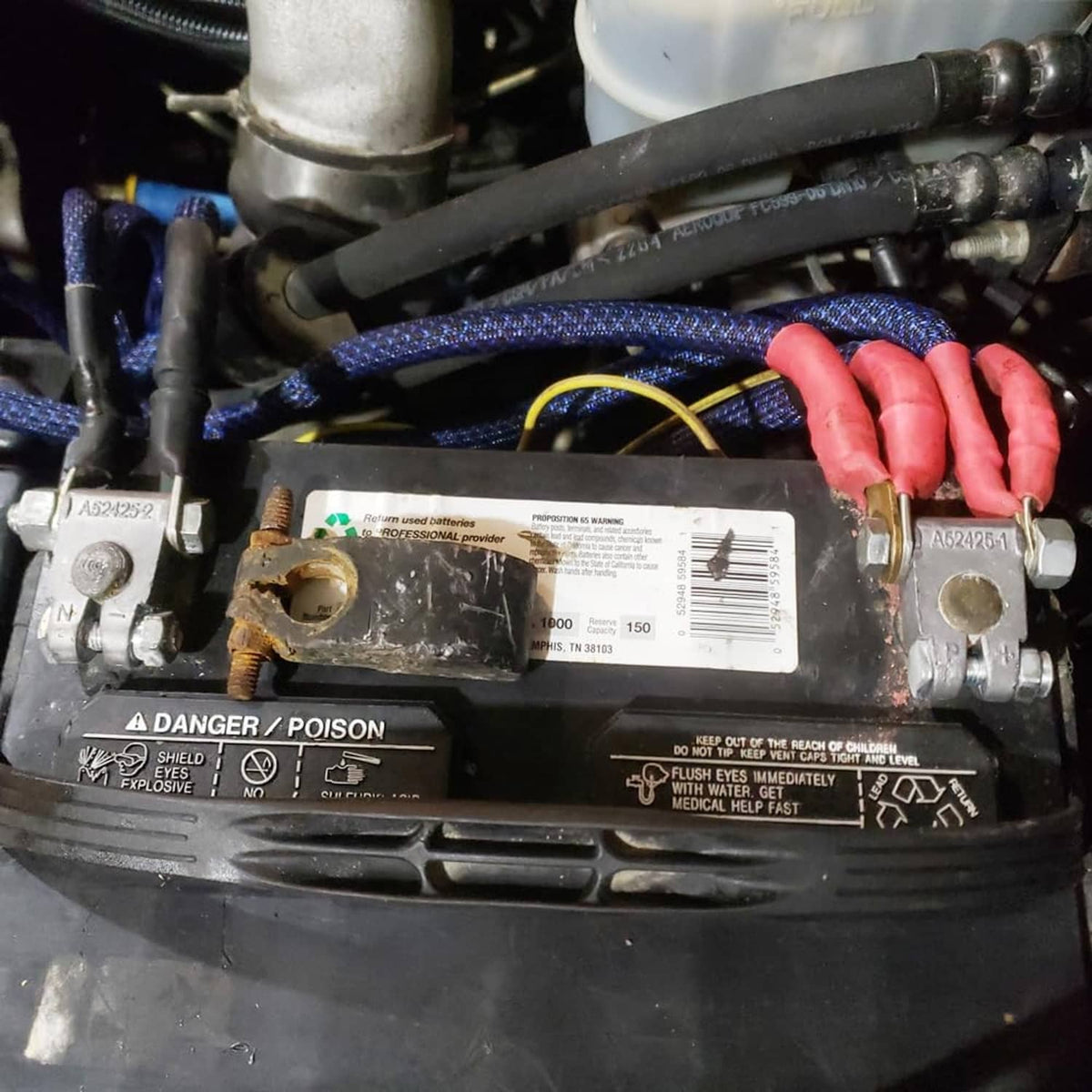 Vehicle battery top-post terminal ends with N and P markings on cable connections