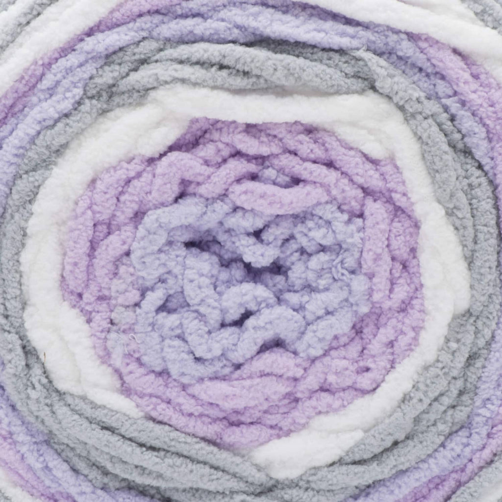 Close-up of self-striping yarn swirl in gray, white, and lavender-purple