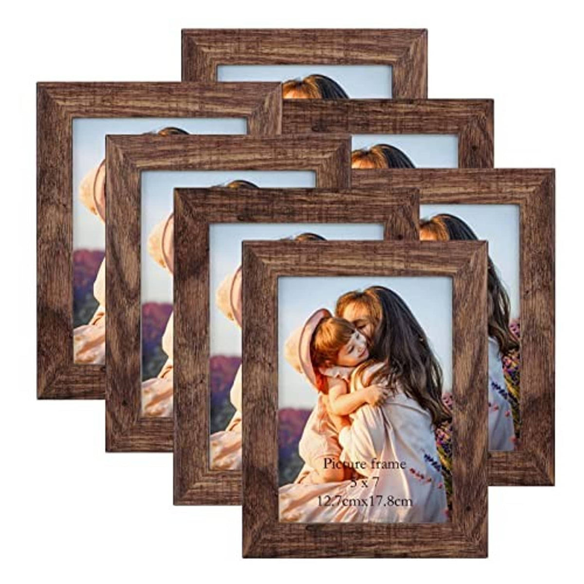 Seven rustic distressed brown picture frames stacked, each with a white photo mat opening