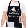 Black kitchen apron with “MR. Good Looking IS COOKING!” graphic and logo tools