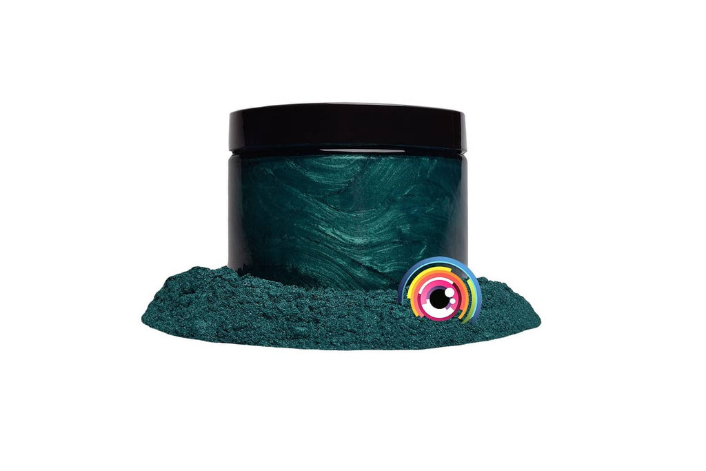 Dark green mica powder jar with mound of dark teal glitter powder
