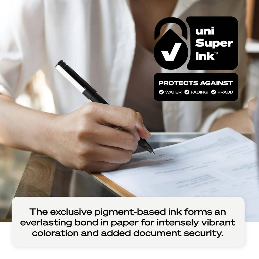 Person signing a document with black rollerball pen with blue tip on desk.