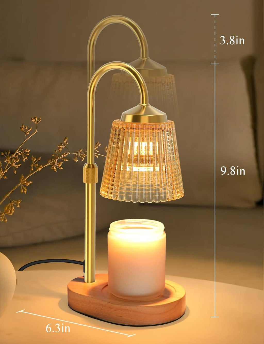 Gold candle warmer lamp on round wood base with height markings and glowing jar candle
