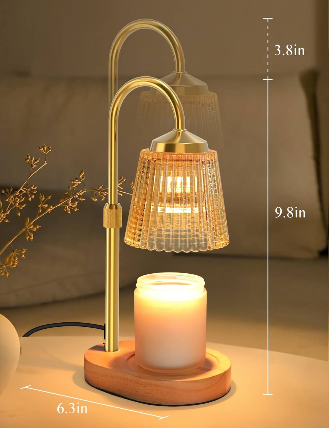 Gold candle warmer lamp on round wood base with height markings and glowing jar candle