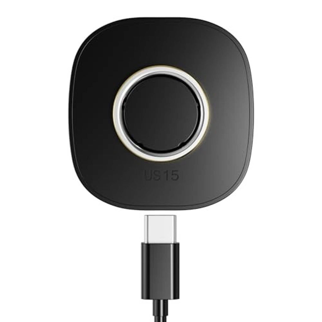 Black charging dock with circular gold ring and USB-C plug connection visible