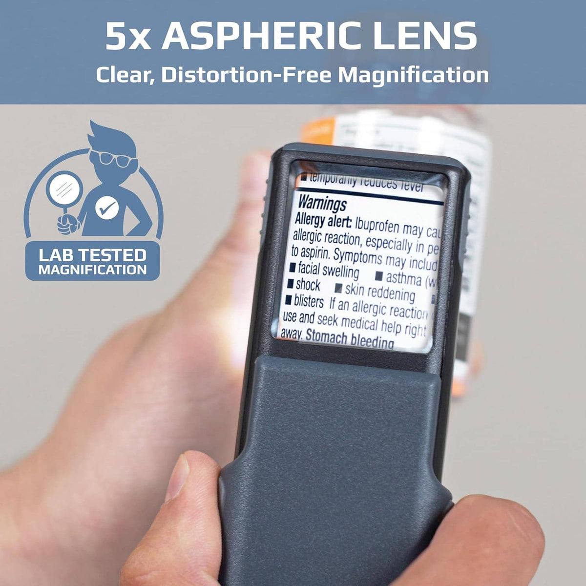 Dark gray LED magnifier in hand with slide-up lens cover, 5x aspheric lens