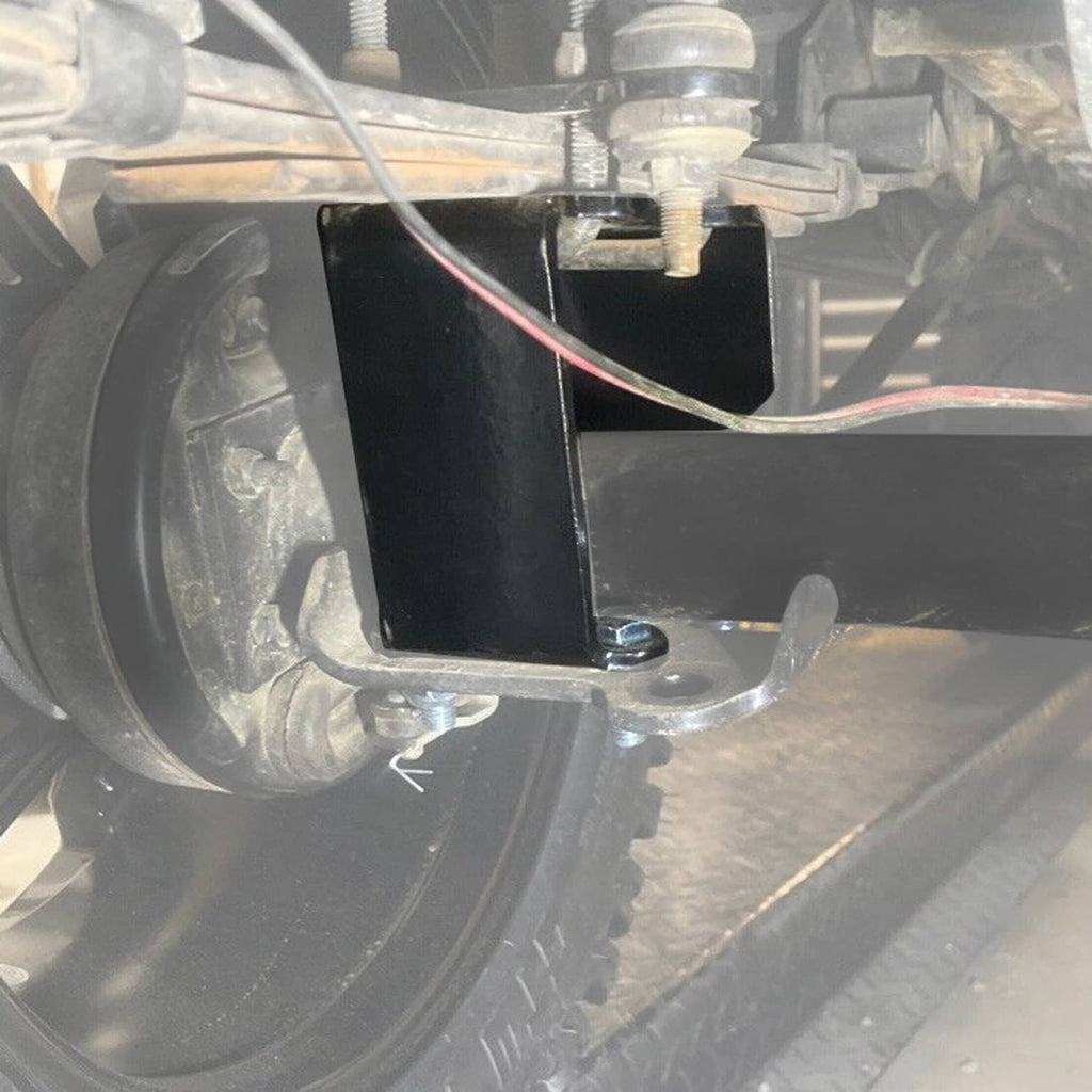 Close-up of black lift bracket mounted to axle with cables and fasteners