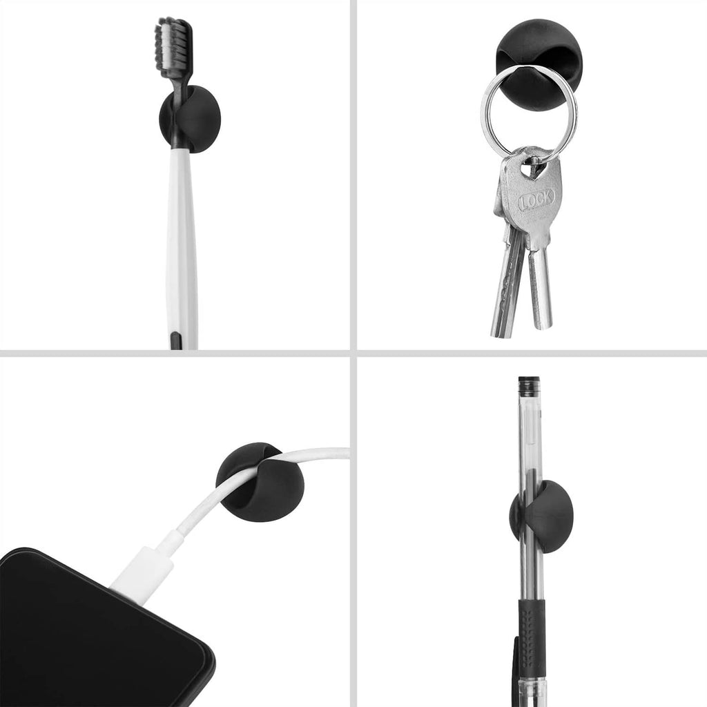Black adhesive cord holder securing a cable; side view with connected key ring