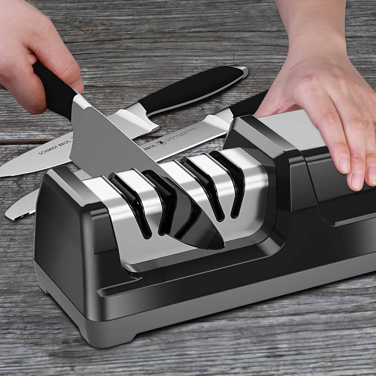 Black ENUTOGO electric knife sharpener showing knife blades inserted in slots