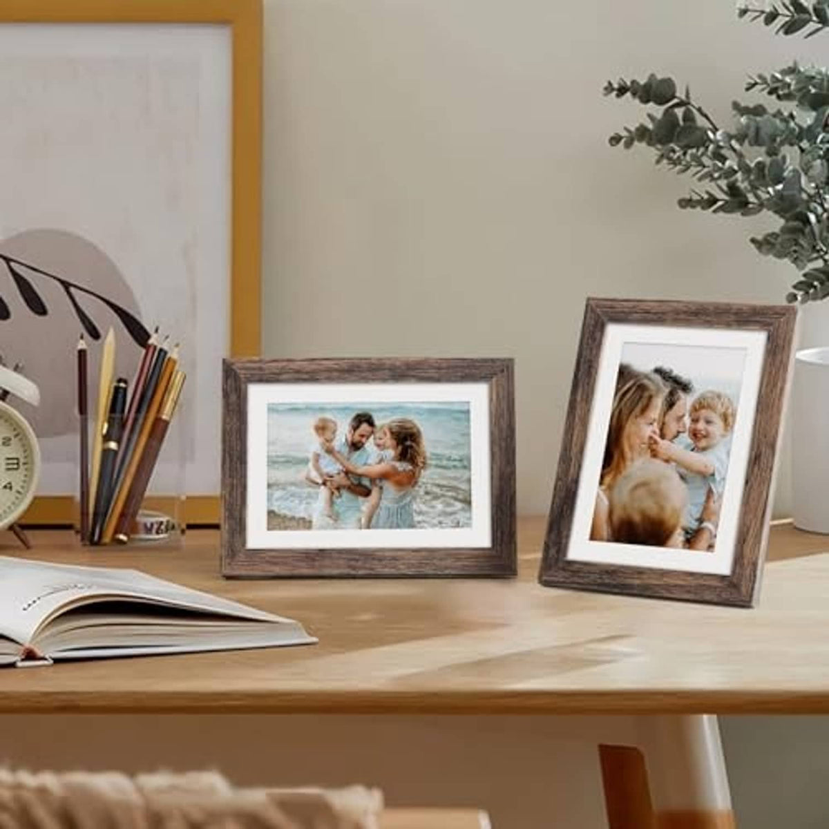 Rustic brown picture frames with photos on desk, tabletop display.