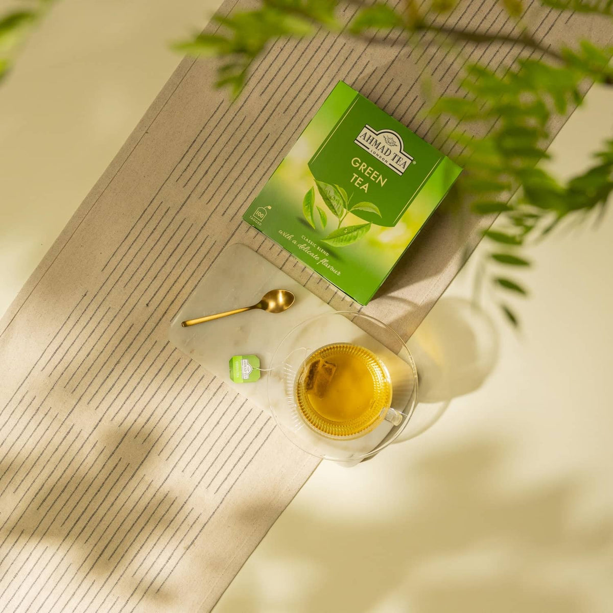 Ahmad Tea Green Tea box with cup, spoon, and small green tea sachet