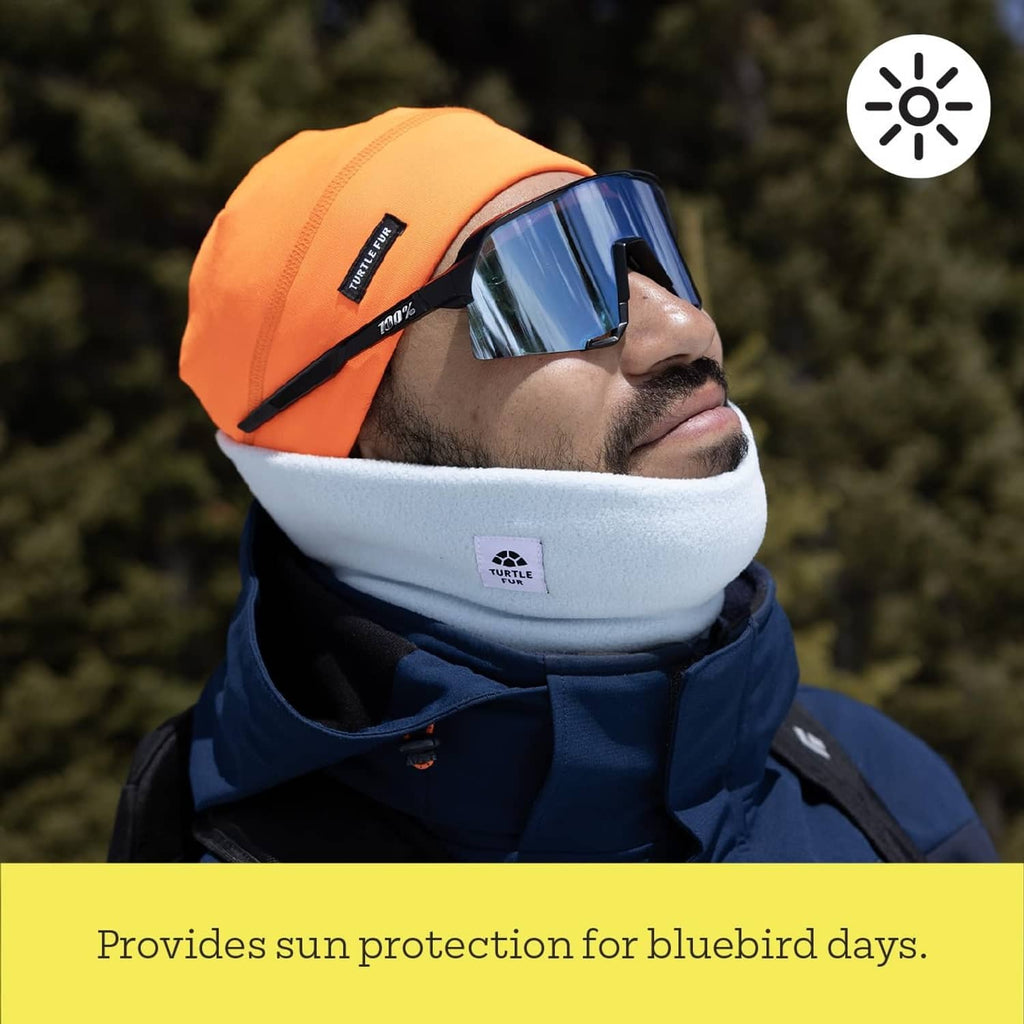 Fleece neck warmer with white inner band and dark outer layer, worn outdoors