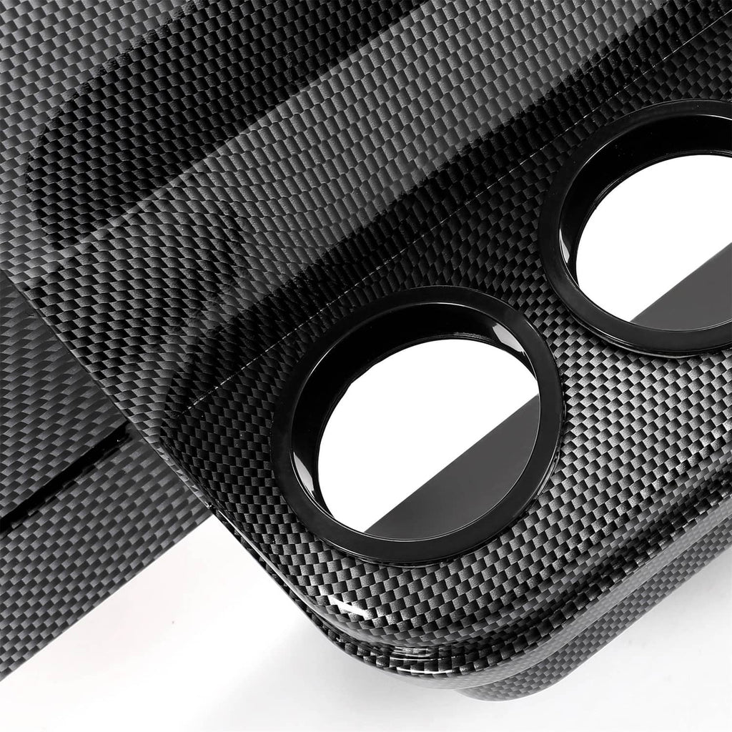 Close-up of carbon-fiber texture dash panel with round cutout openings