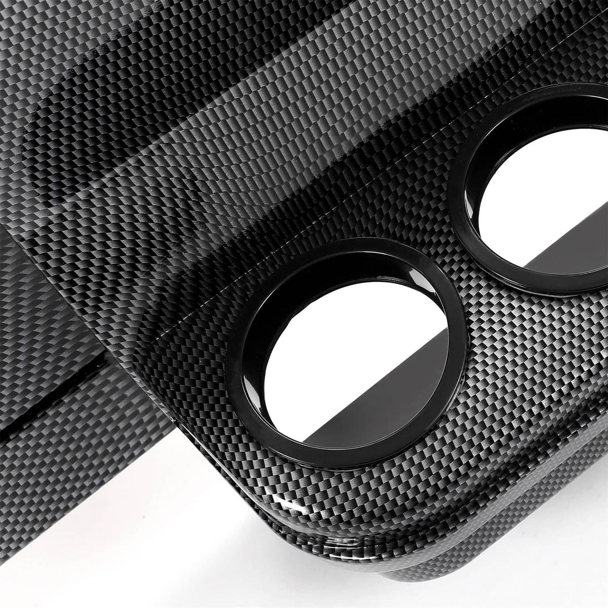 Close-up of carbon-fiber texture dash panel with round cutout openings