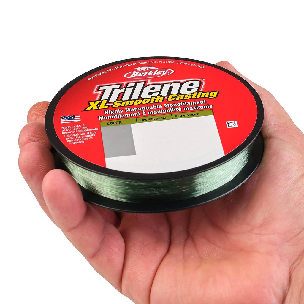 Green fishing line spool in hand labeled Trilene XL Smooth Casting, low-vis green color