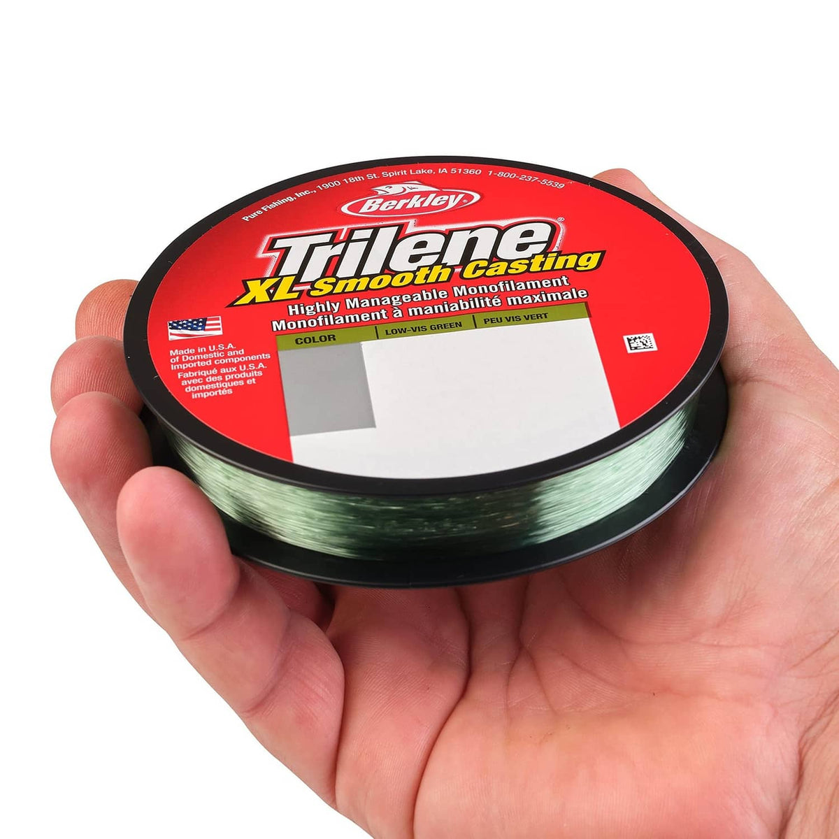 Green fishing line spool in hand labeled Trilene XL Smooth Casting, low-vis green color