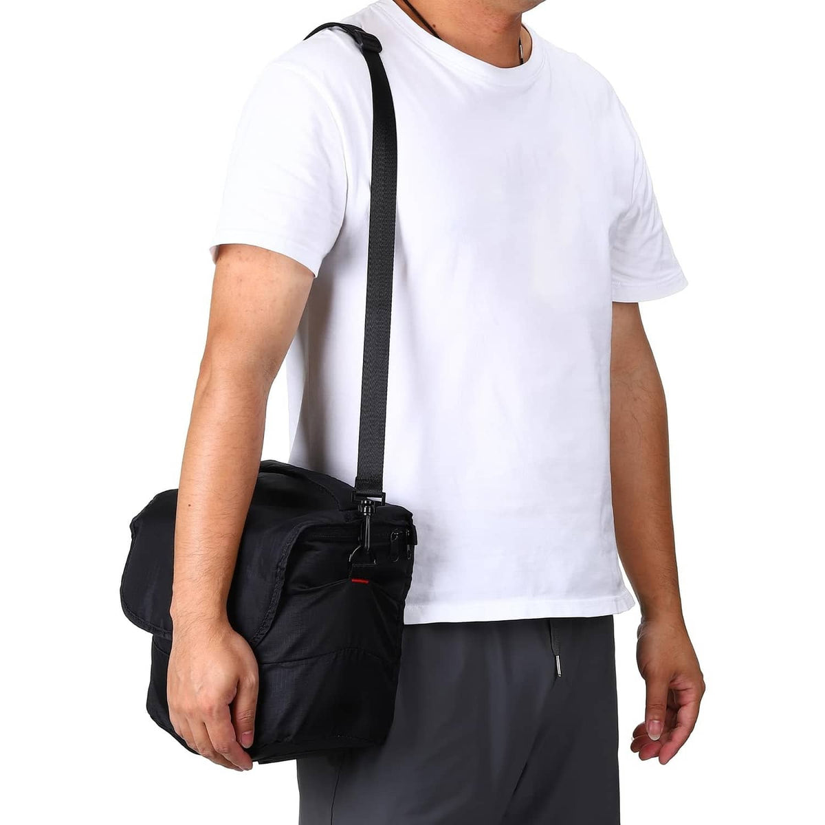 Black adjustable shoulder strap worn crossbody with metal swivel hooks and buckle