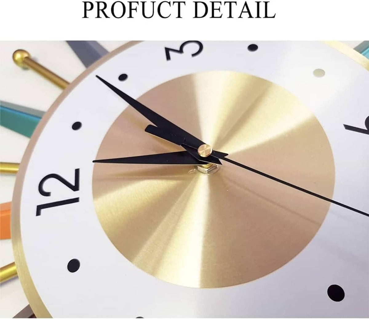 Starburst wall clock close-up with gold ring, black hands, and white dial.