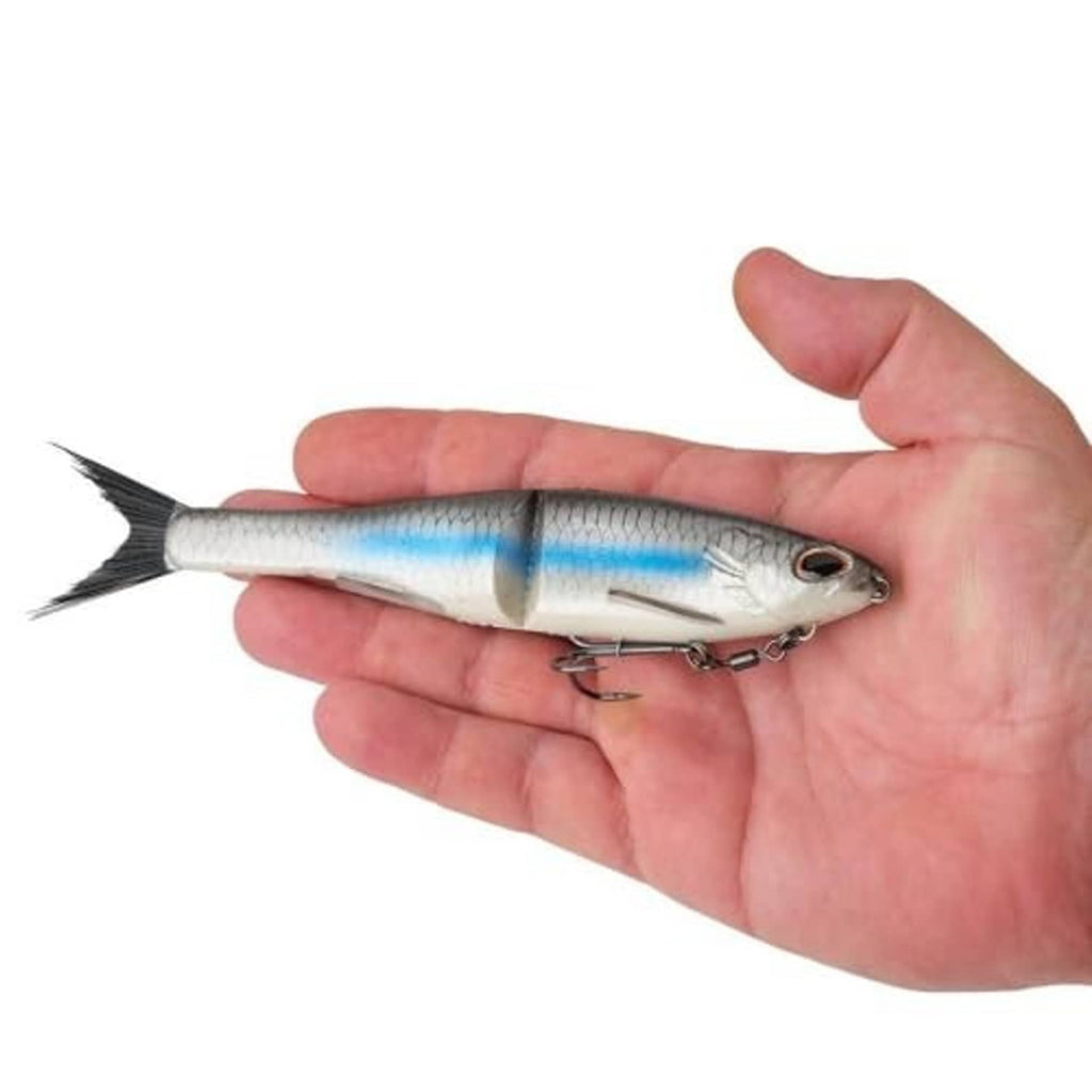 Glide bait soft plastic lure held in hand, silver-blue body and treble hooks