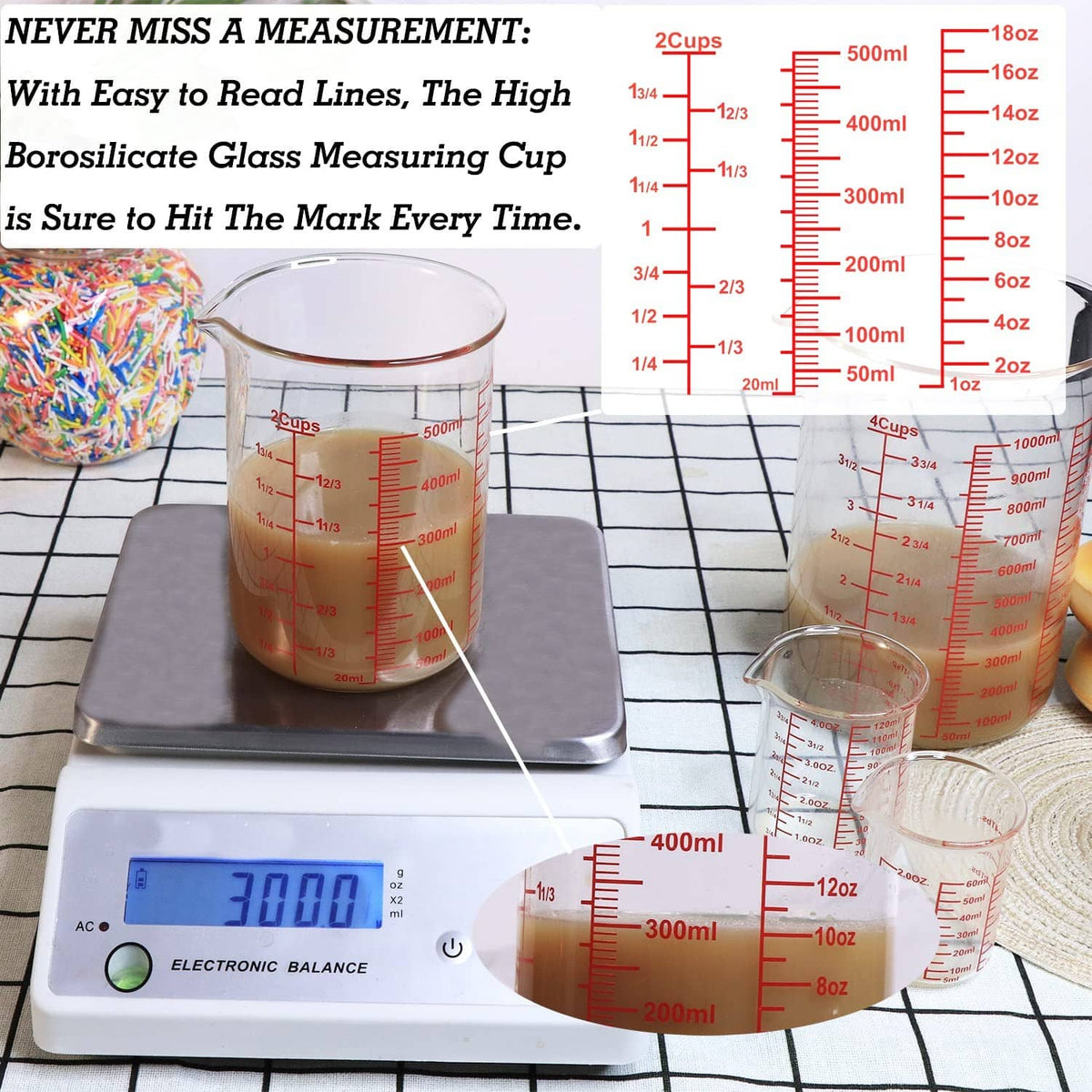 Clear glass measuring cup with red measurement scale and wide rim, up to 500 ml