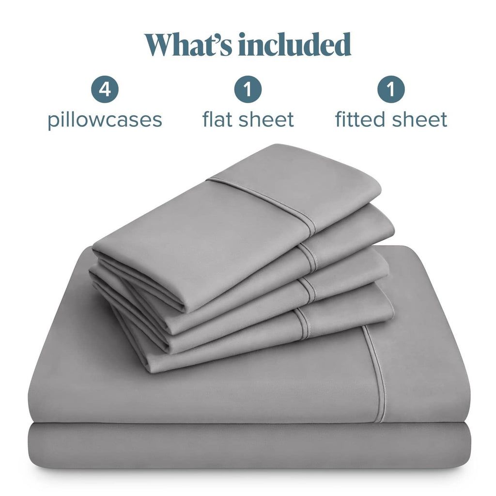 Light grey microfiber linen set, folded with four pillowcases plus flat and fitted sheets