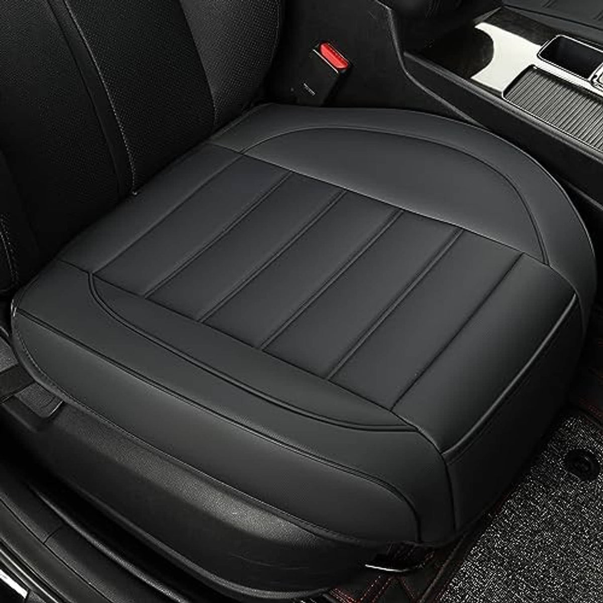 Black front seat bottom cover close-up with stitched center panels and smooth top edge