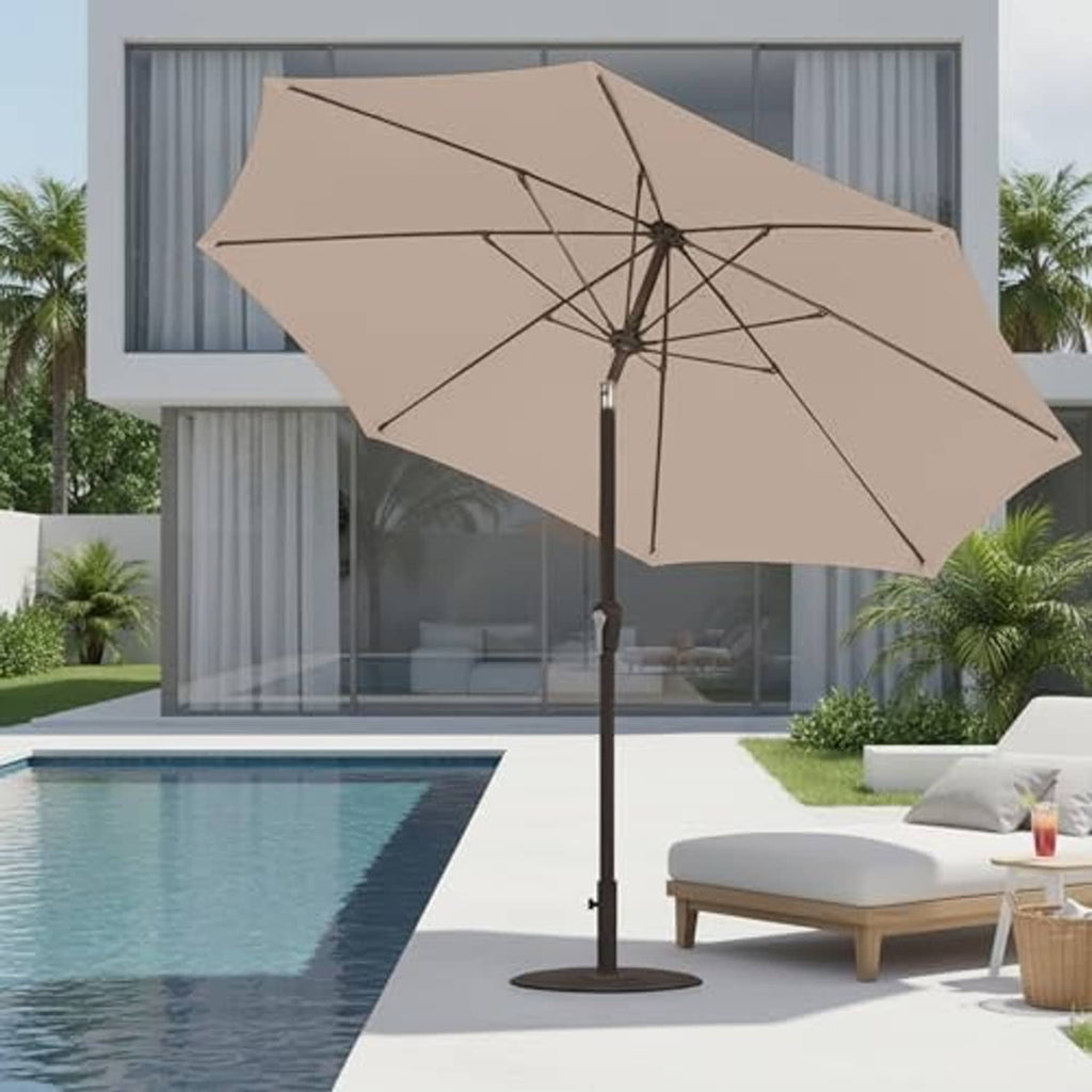 Beige patio umbrella angled open with dark pole stand, canopy ribs visible