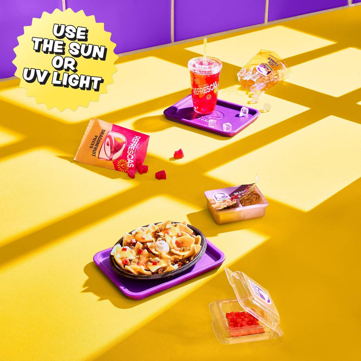 Mini Taco Bell accessory set with small plastic cups, tortilla packets, and taco tray