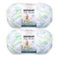 Two Bernat Super Bulky yarn skeins in pastel stripes of blue, green, and white