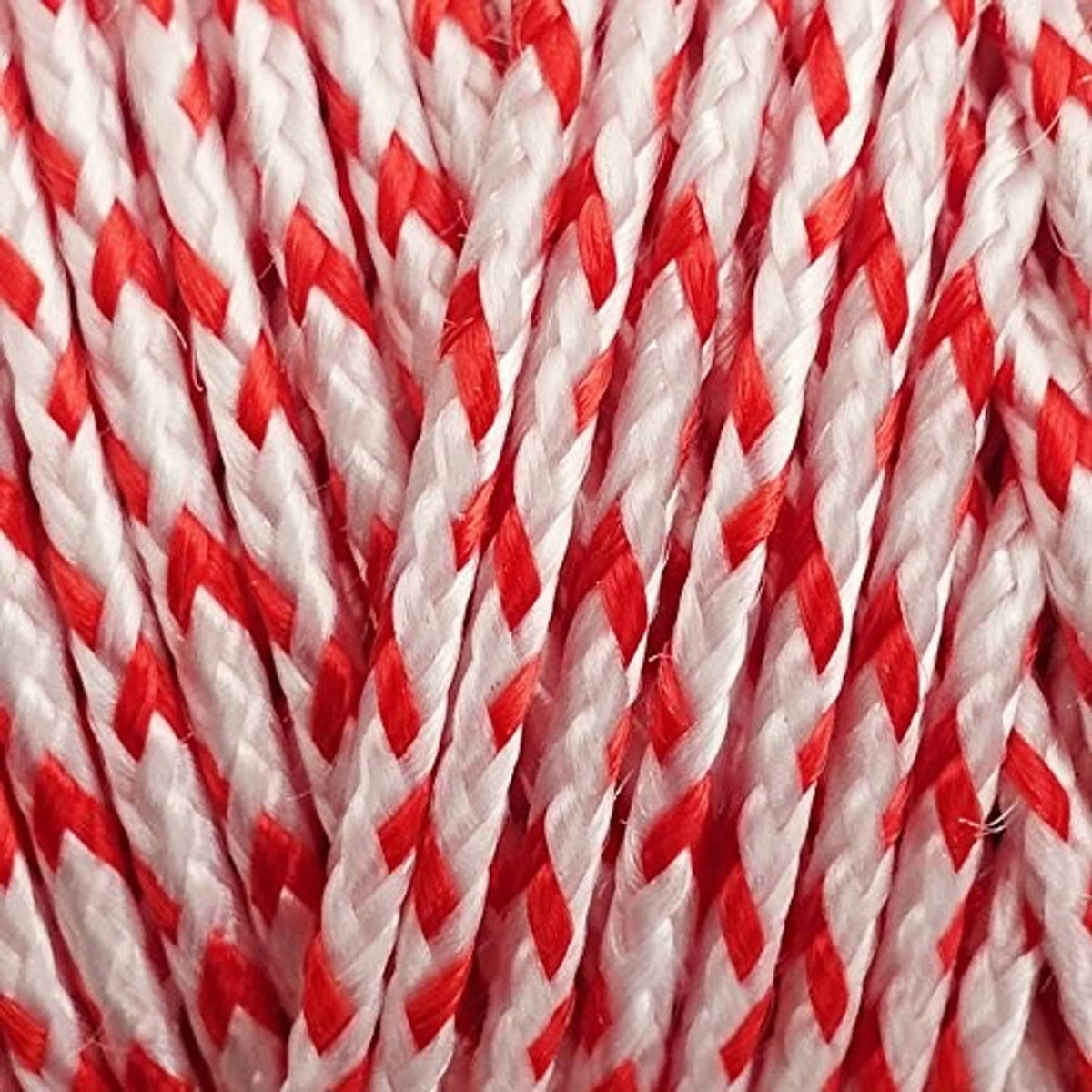 Close-up of red and white braided Dacron kite line rope texture.