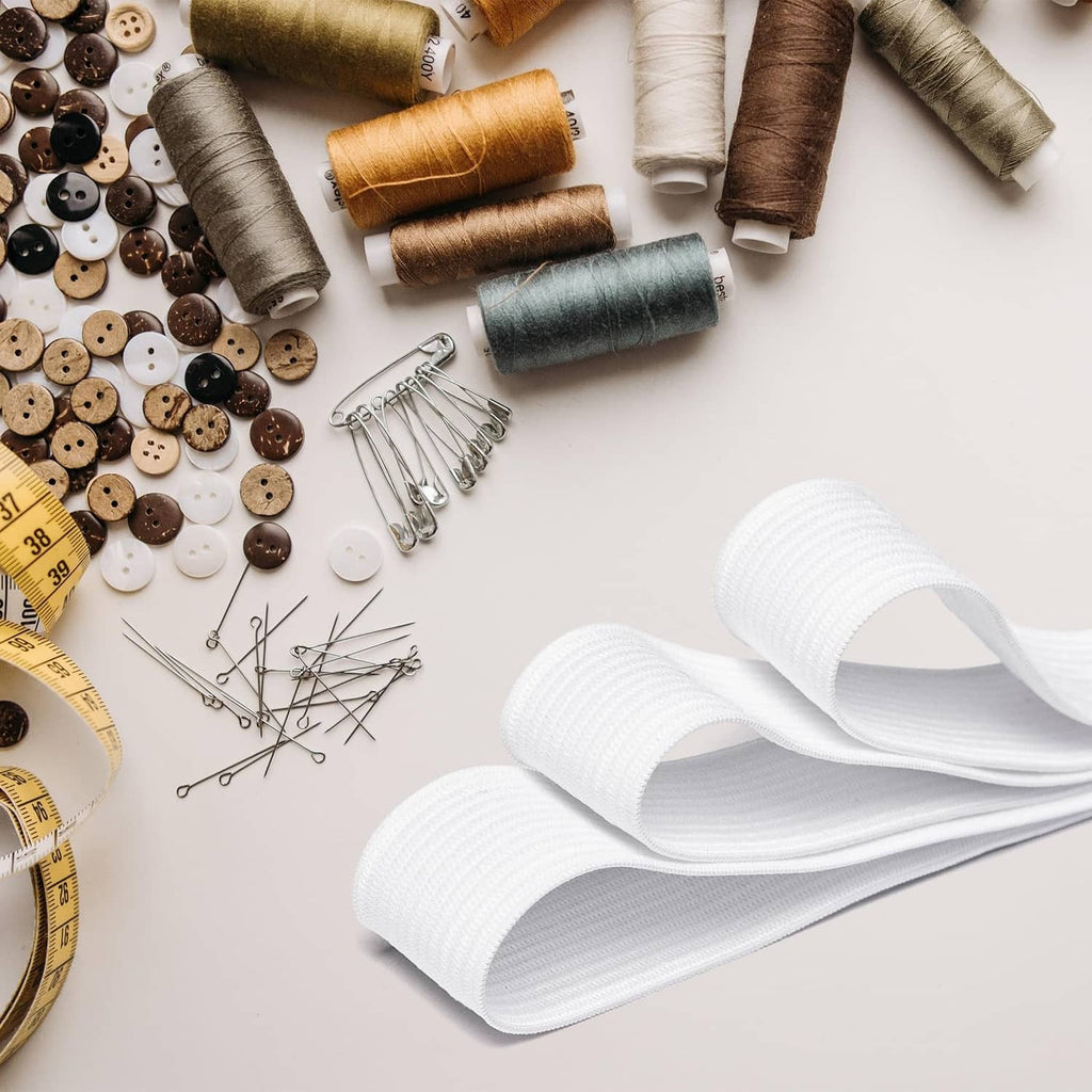 White 3/4 inch sewing elastic band rolls on a craft table