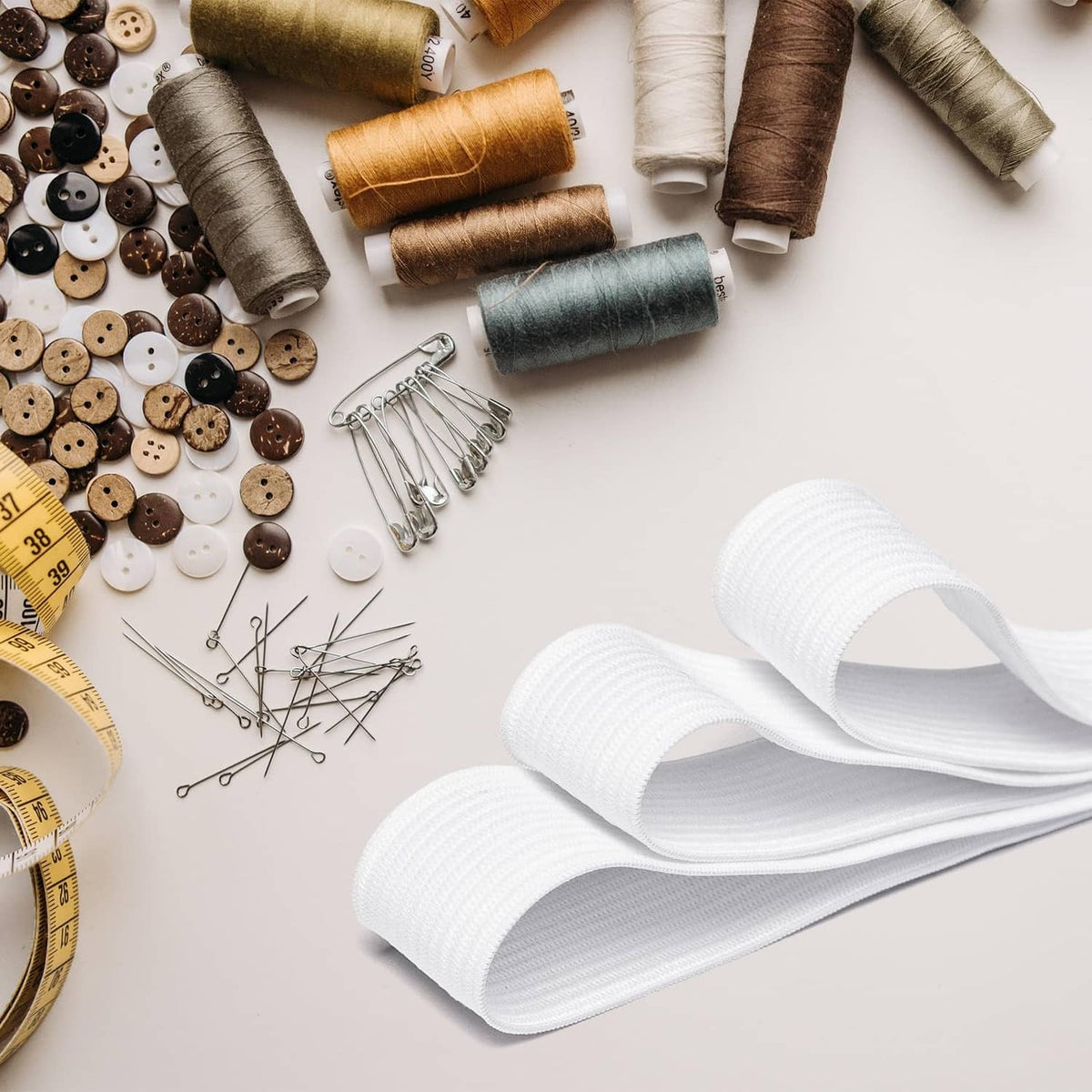 White 3/4 inch sewing elastic band rolls on a craft table