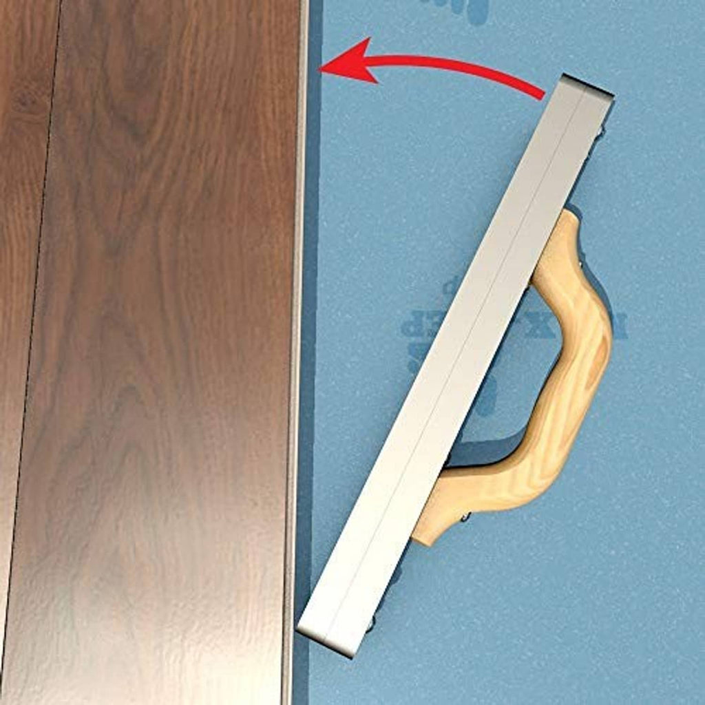 Flooring tapping block inserting along board seam, light wood striker over underlay