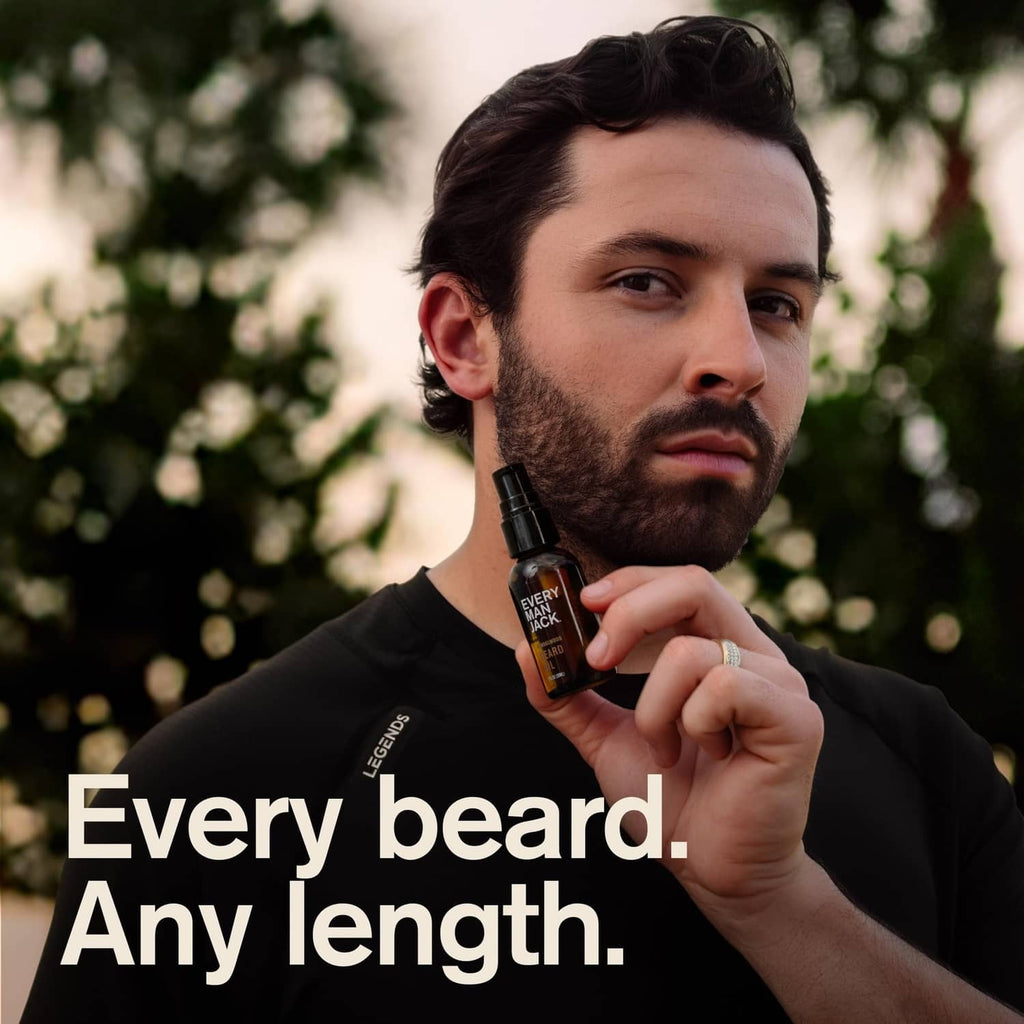Bearded man holding Every Man Jack beard oil bottle with pump
