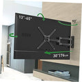Black full-motion TV wall mount holding a TV on an interior wall
