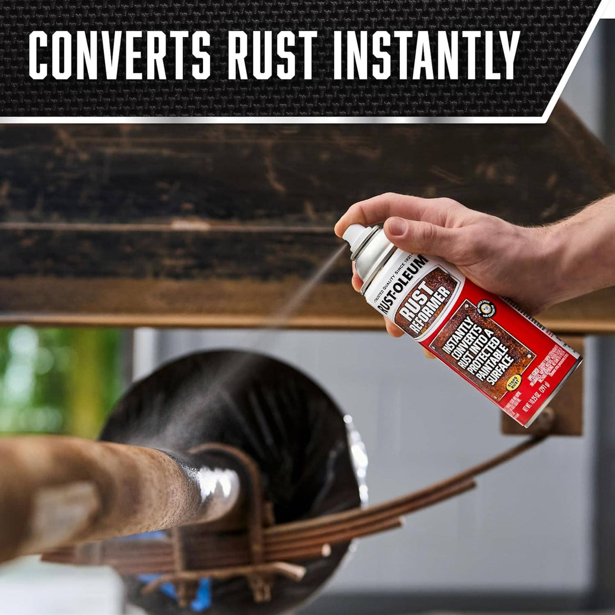 Hand spraying Rust-Oleum Rust Reformer onto metal rail surface