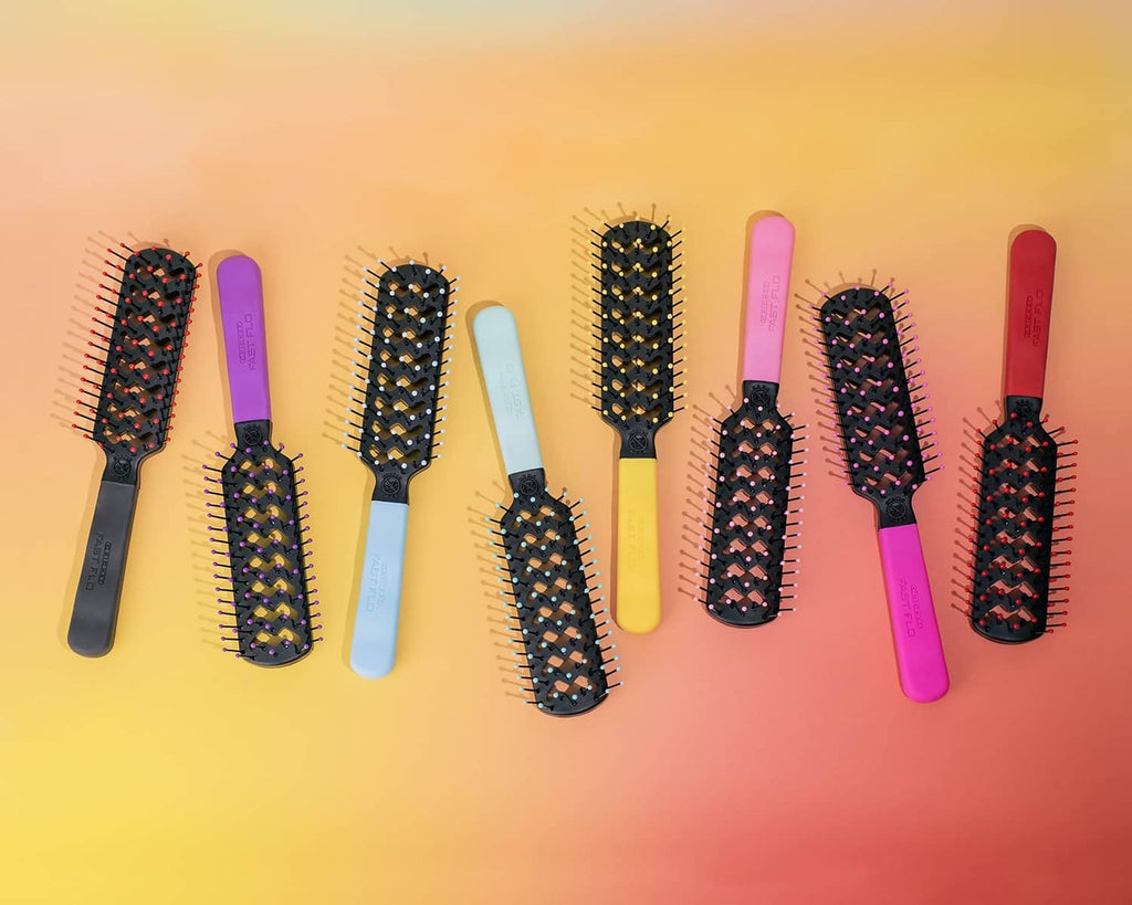 Assorted vented hair brushes lined up with black bristle heads and colorful handles